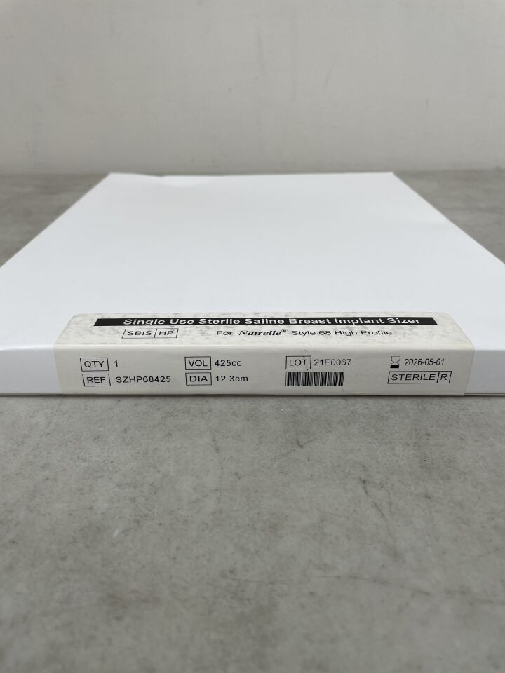 Sterile saline breast implant sizer box, volume 425cc, diameter 12.3cm, on gray surface