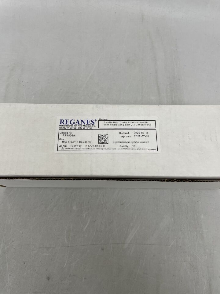 Box of REGANES epidural needles, sterile medical supplies on a gray background