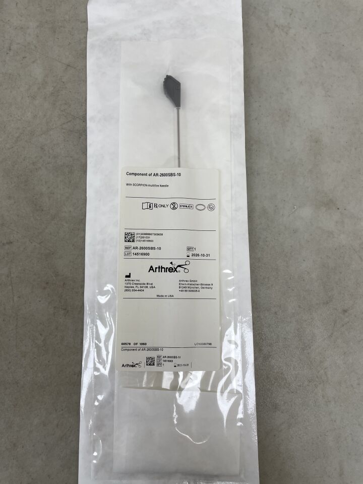 Sterile packaged medical needle with black handle on a labeled white pouch, used for surgical procedures