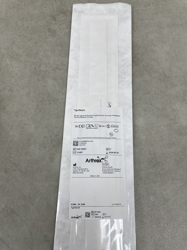 Arthrex TigerStick surgical suture in sterile white packaging on gray surface