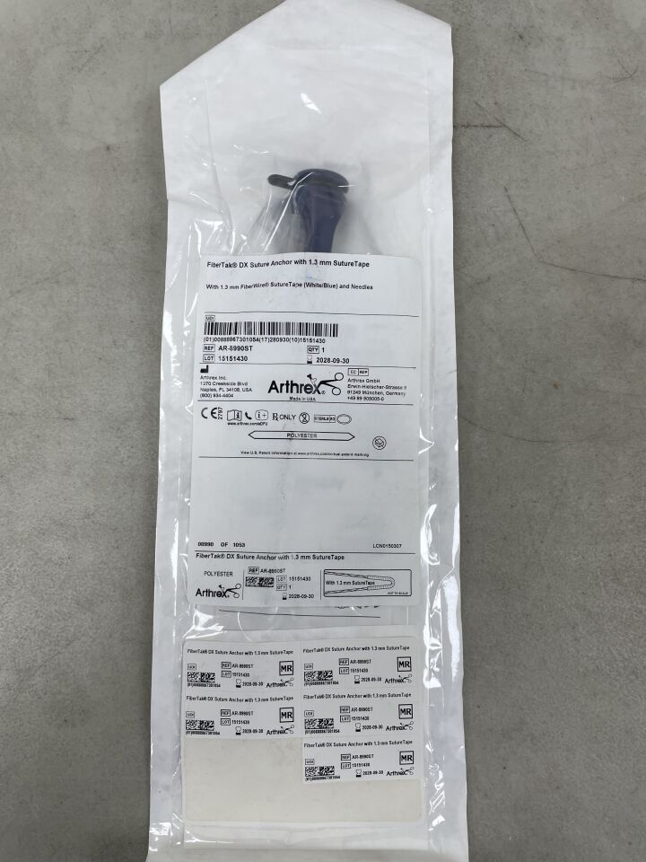 FiberTak DX suture anchor with 1.3 mm suture tape in sterile medical packaging on gray surface