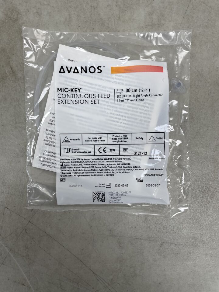 AVANOS MIC-KEY continuous feed extension set in sealed medical packaging on gray surface