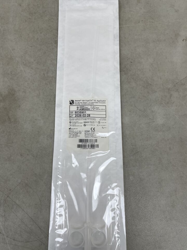 Sterile medical applicator in sealed packaging on a gray surface